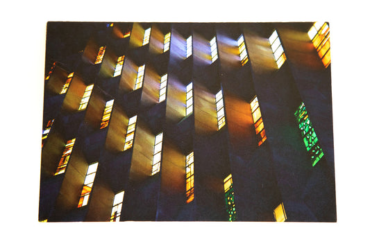 Greetings card featuring coloured light from stained glass windows washing concrete walls at Coventry cathedral